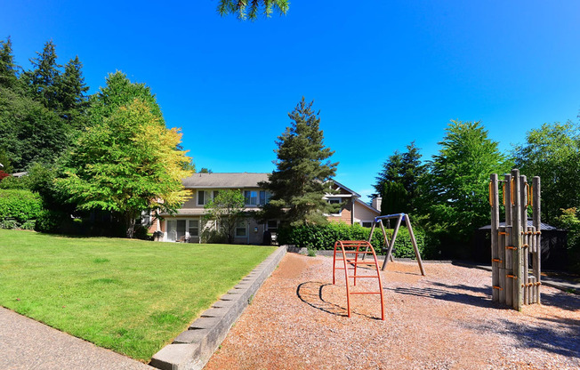 Three-Bedroom Apartments in Issaquah, WA - Langara - Playground with Woodchip-Covered Ground, Swing, and Climbing Structures