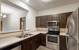 a kitchen with a stove and a refrigerator