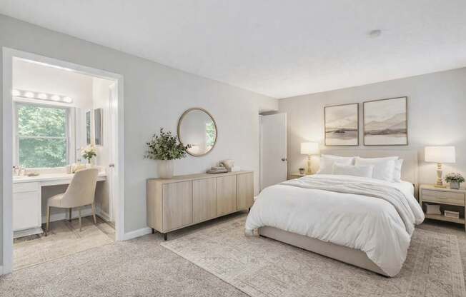 A bedroom with a large bed, a desk with a chair, and a window.