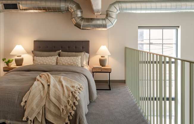 a bedroom with a bed and a window at The 22 Apartments, St. Louis, MO 63103