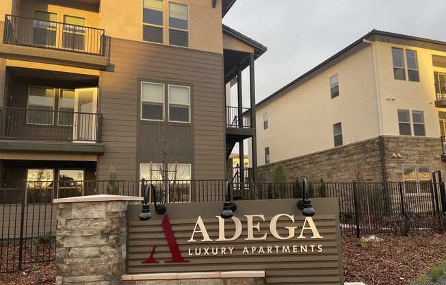 an adega luxury apartments sign in front of an apartment building