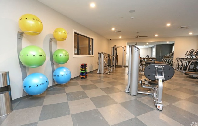 a gym with a bunch of exercise equipment and balloons on the floor at Century Baxter Avenue, Kentucky