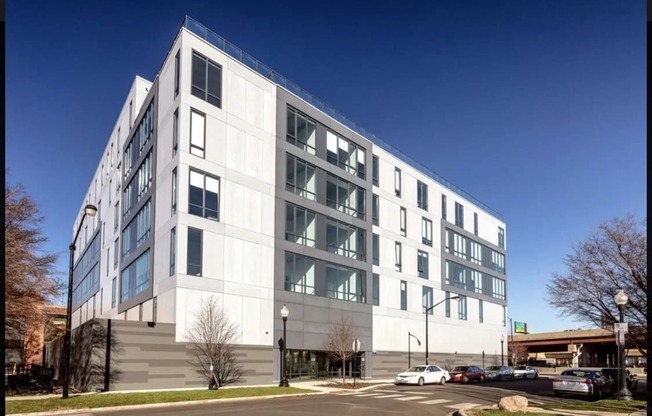 a large white building with cars parked in front of it