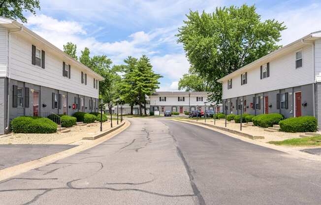 A street view of a residential area with houses on both sides at Spring Creek Townhomes Apartments, Springfield 62702