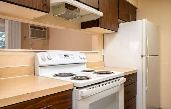A white stove and refrigerator in a kitchen.