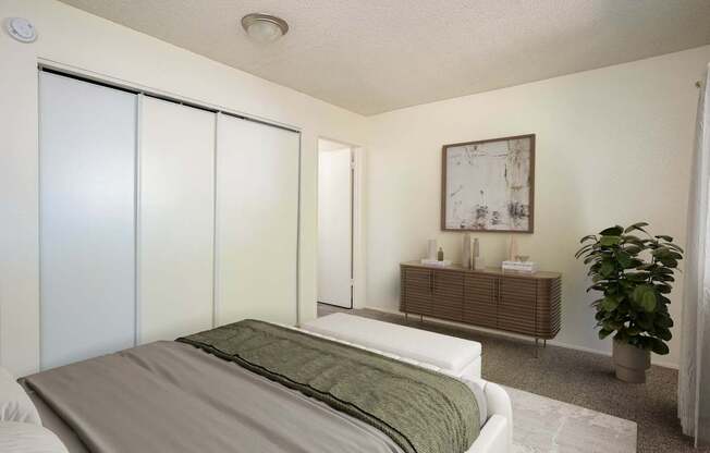 A bedroom with a bed, a plant, and a painting on the wall.