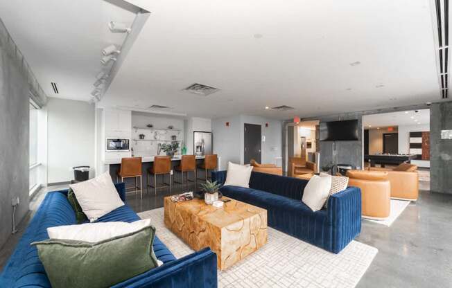 A living room with a blue couch and a coffee table.
