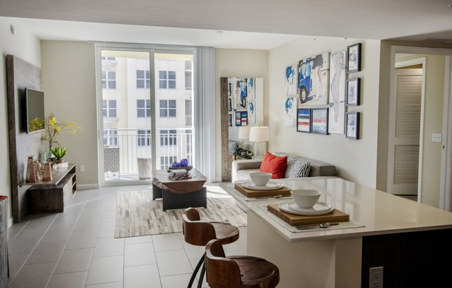a living room and dining room with a table and chairs