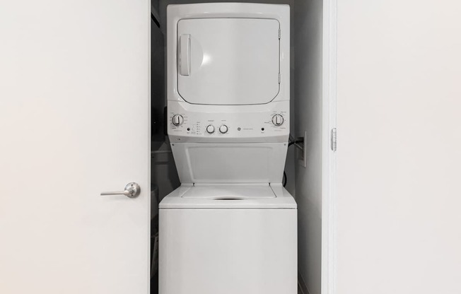 an empty laundry room with a washer and dryer