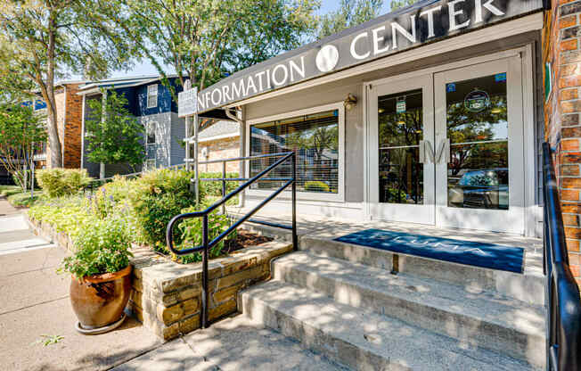 the front of the information o center building with stairs and plants