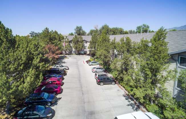 a parking lot with cars in front of a building