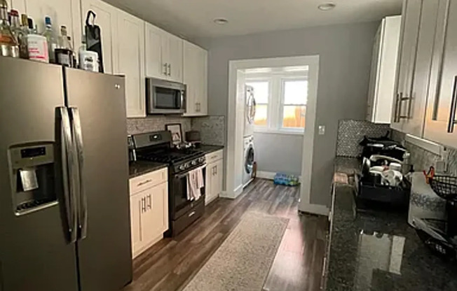 Modern 3 Bedroom 1.5 Bath South Philly Home with laminate floors, W/D in unit, C/A, Yard and more!