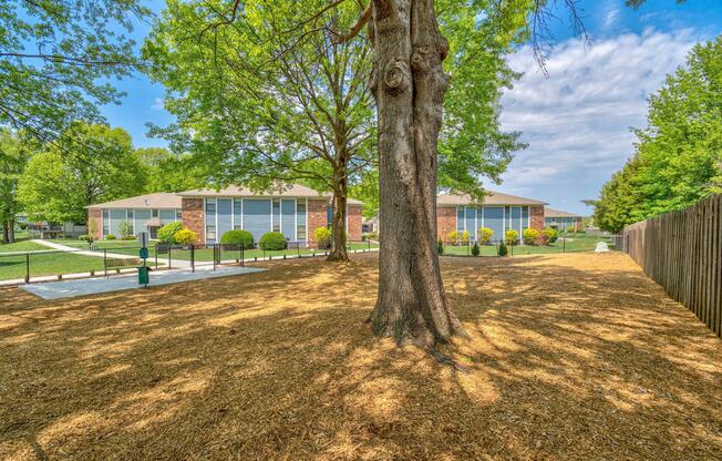 Gated dog park filled with mulch at The Arbor Apartments in Blue Springs, Missouri