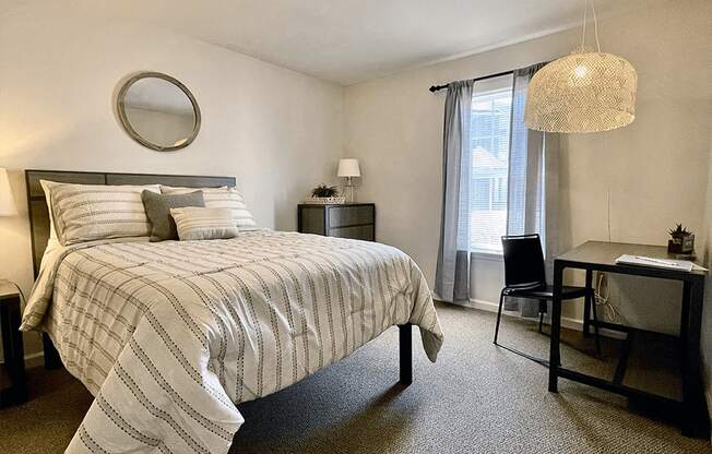 bedroom with window and space for a desk