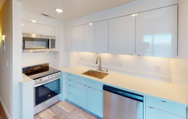 a kitchen with white cabinets and blue countertops