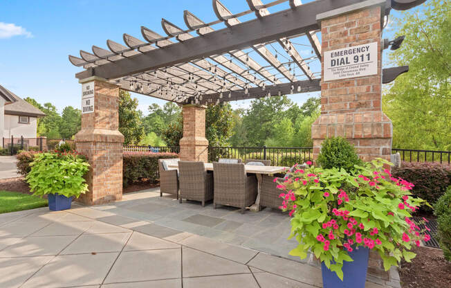 a patio with a table and chairs and a pergola