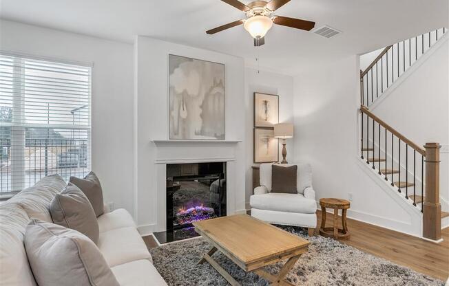 a living room with a couch and a coffee table and a fireplace