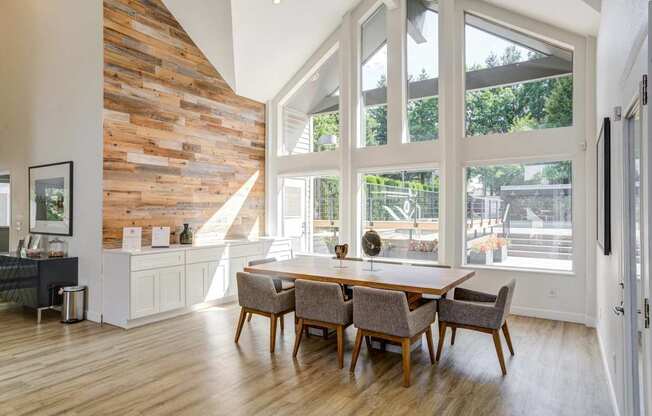 A dining room with a wooden table and chairs.
