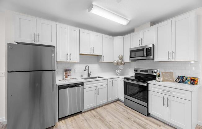 a kitchen with a stove sink and refrigerator