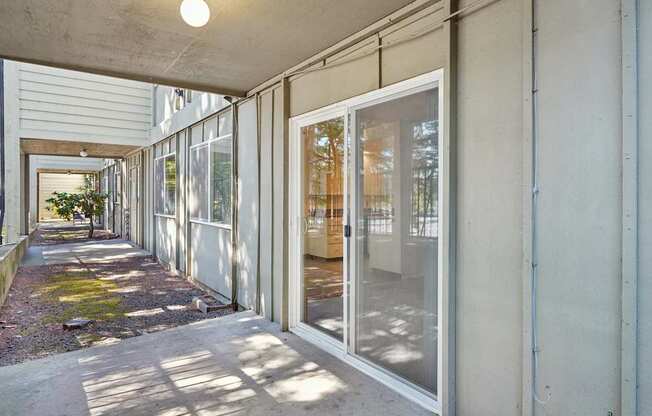 A long corridor with glass doors and windows on the side.