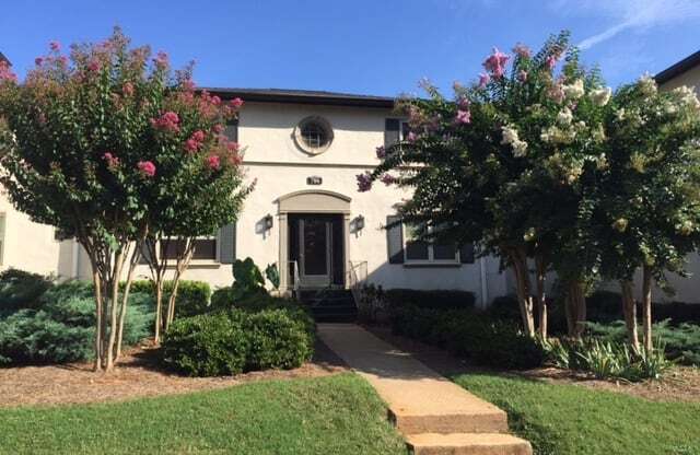 a large white house with trees in front of it at Avondale Station Apartments, Georgia