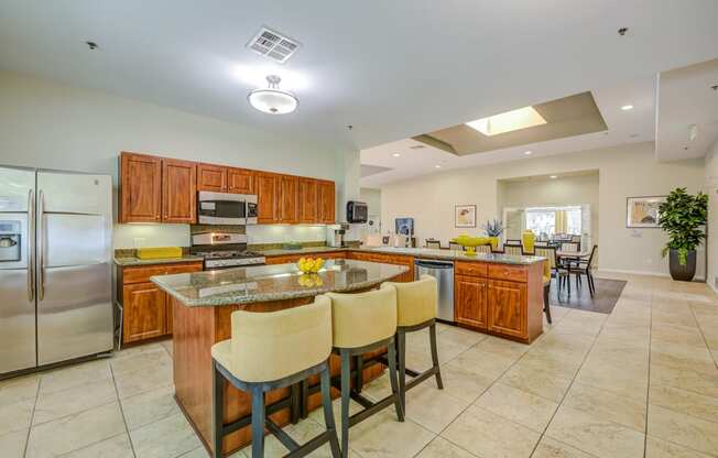 a large kitchen with granite countertops and stainless steel appliances