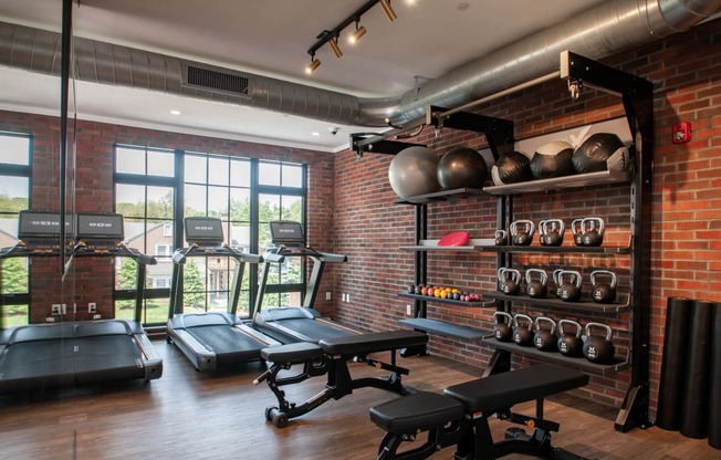 a gym with brick walls and a large window