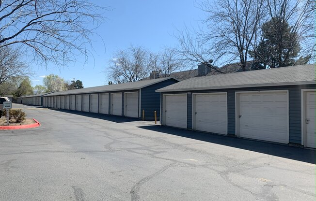 a row of garages with a blue sky in the background