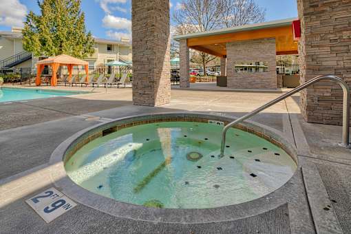 A hot tub in the middle of a pool area with a sign that says 29m.