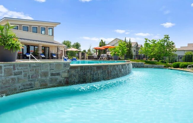 a large swimming pool with a building in the background