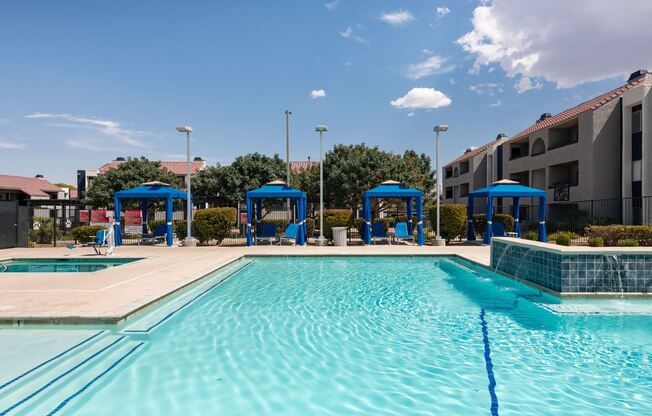 our apartments have a large swimming pool with blue cabanas