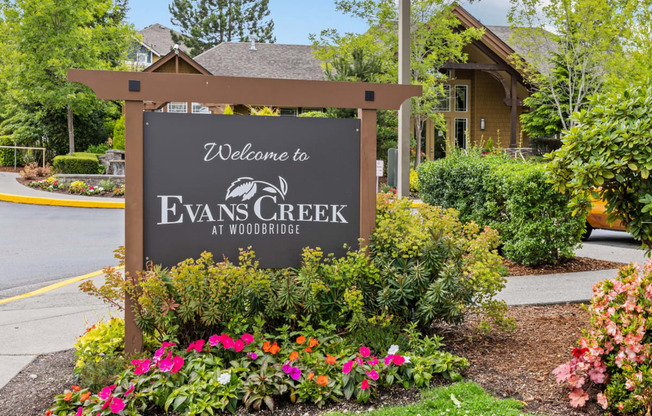 a sign that says welcome to evans creek at woodbridge