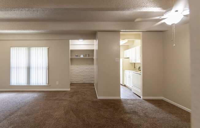 This is a photo of the living room and dining area in the 965 square foot 2 bedroom, 2 bath  apartment at Harvard Square Apartments, in Dallas, TX.