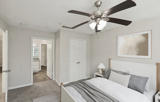 Model Bedroom with Carpet and attached Bathroom at Shadow Ridge Apartments in Riverdale, GA.