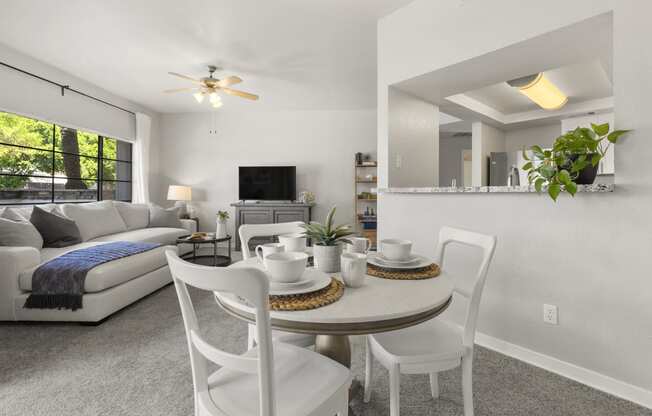 a living room with a table and chairs and a couch at Vaseo Apartments, Arizona
