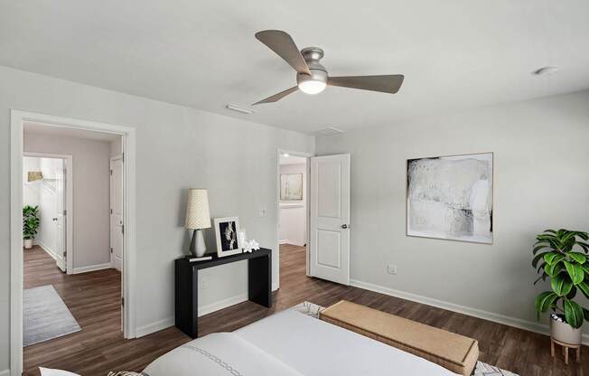 a bedroom with a large bed and a ceiling fan