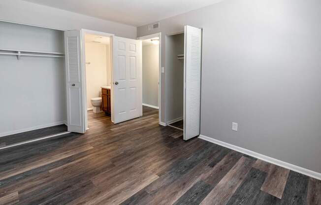 a bedroom with a closet and a door to a bathroom