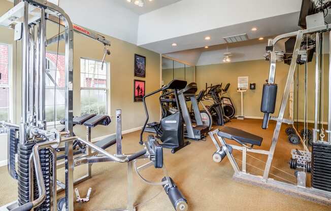 Fitness Center with exercise equipment, three windows and a mirror accent wall.