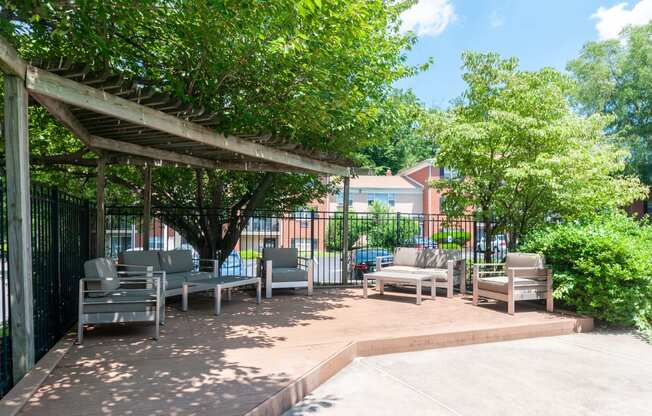 a patio with chairs and a pergola