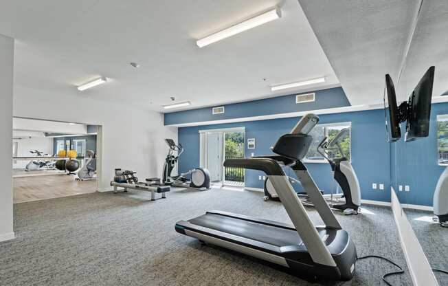 the gym with treadmills and other exercise equipment at the belgard apartments