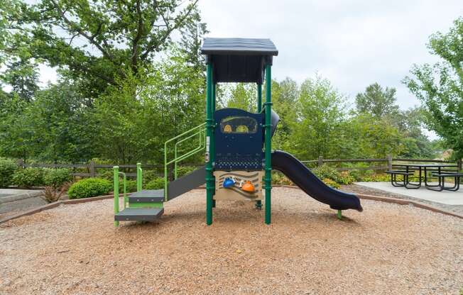 a swing set with a slide in a park