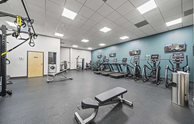 a large fitness room with cardio equipment and weights  at The Icon, Virginia, 23230