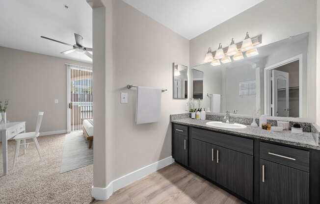 a bathroom with a sink and a mirror, light fixture mounted