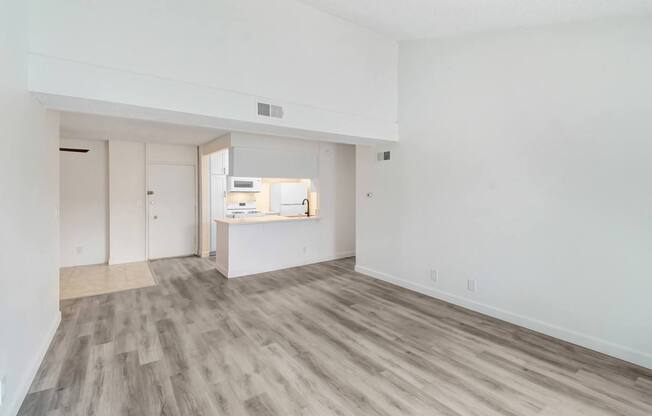 A room with a white wall and a grey floor.