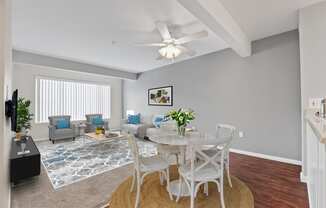 a living room with a ceiling fan and a large window