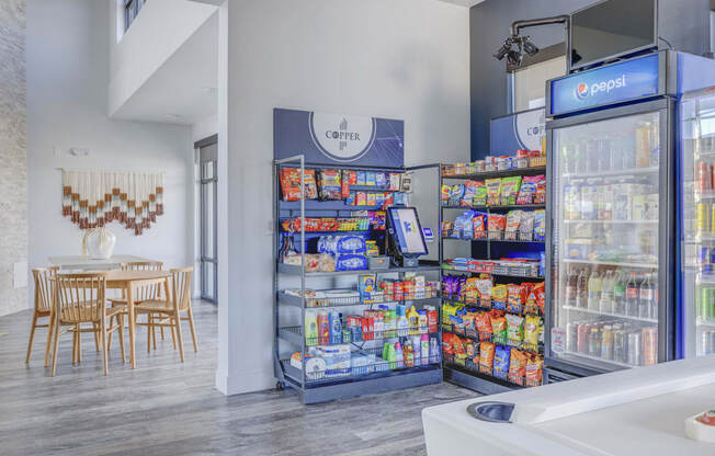 a pantry with two refrigerators and a table and chairs in the background at Copper 87, West Jordan