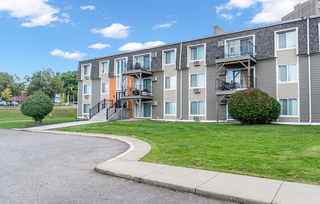 Apartment building with a green lawn in front.
