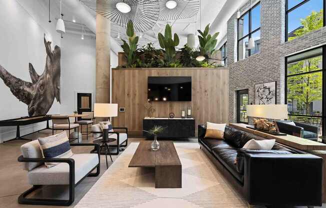 A living room with a large sofa, a coffee table, and a mounted TV.