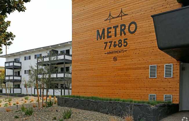Building exterior wooden paneled wall Metro 77& 85 signage