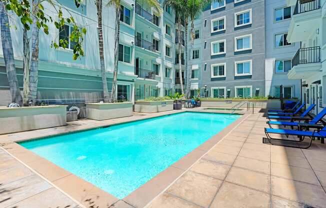 an apartment with a swimming pool in front of a building   at Apex Mission Valley, San Diego, California